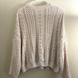 An off-white cream color sweater. Size Medium. No tags on it.